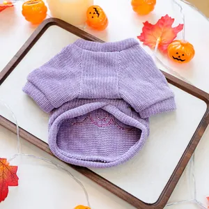Close-up of purple corduroy pet sweater with festive BOO embroidery for Halloween.
