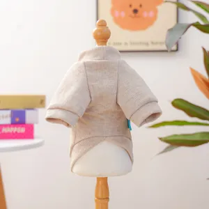 Close-up detail of the beige ribbed knit pet sweater showing fabric texture and back cut