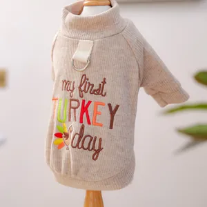 Close-up detail of beige ribbed pet sweater with My First Turkey Day embroidery and D-ring