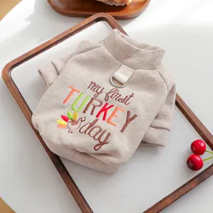 Detail of beige corduroy pet sweater with 'my first TURKEY day' embroidery and D-ring