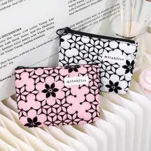 Floral print portable cosmetic pouch and coin purse with milobliss tag in pink and white