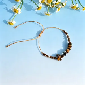 Close-up view of a natural tiger's eye crushed stone beaded braided cord wrist strap