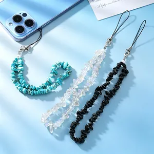Detail shot of three natural stone beaded phone lanyards in blue, white, and black