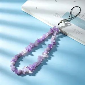 Detailed macro view of handmade natural amethyst stone chip beaded phone wrist strap