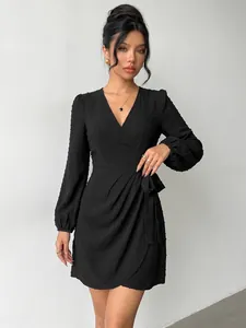 Detailed macro view of the black V-neck dress featuring unique Swiss dot textured fabric.