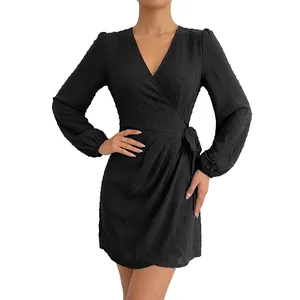Elegant black long sleeve V-neck wrap mini dress featuring delicate swiss dot texture