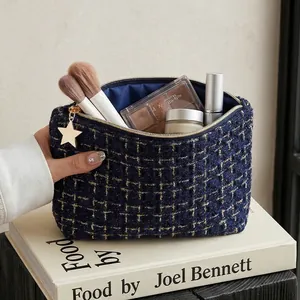 Elegant navy blue tweed cosmetic bag with gold star charm for makeup travel storage