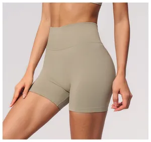 Close-up detail of khaki seamless high-waist yoga shorts showing ribbed waistband texture