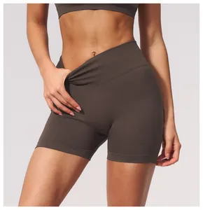 Detail view of seamless high waisted yoga shorts showing waist compression on fitness model