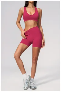 Premium seamless high-waisted yoga shorts and sports bra set in vibrant magenta pink.