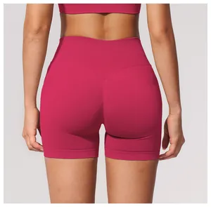 Close-up back view of women's seamless high-waisted gym shorts in vibrant deep pink