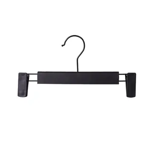 Sturdy matte black pants hanger with adjustable non-slip clips on white background