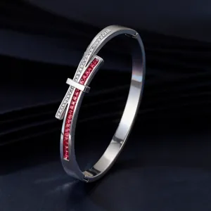 Macro view of bow design silver bangle with red square stones and rhinestones
