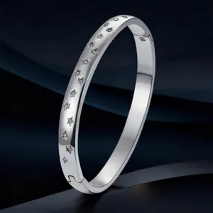 Silver stainless steel bangle featuring delicate engraved stars with sparkling rhinestones.