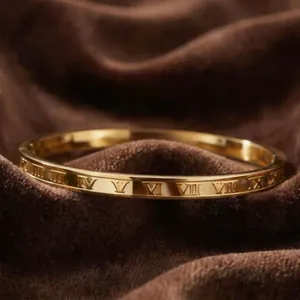 Elegant gold titanium steel bangle featuring classic engraved Roman numeral detailing