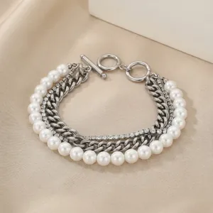 Detail of multi-layer stainless steel bracelet with shell pearls and zircons