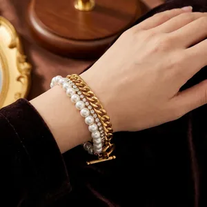 Close-up view of a multi-layer stainless steel bracelet with pearls and zircon stones