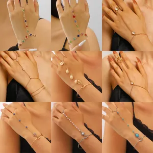Selection of elegant gold finger-linked slave bracelets with pearls and heart charms
