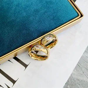 Close-up of vintage gold titanium steel rings with clear square and marquise stones