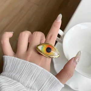 Detailed close-up view of a vintage gold-plated ring featuring a large evil eye design