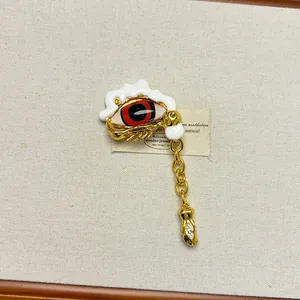 Detailed view of vintage gold evil eye ring with melting enamel design and hanging chain