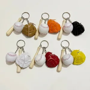 Detailed view of mini baseball keychains with colorful leather gloves and wooden bats.