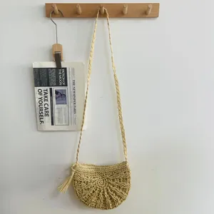 Handmade straw woven crossbody bag for summer beach vacation with tassel detail