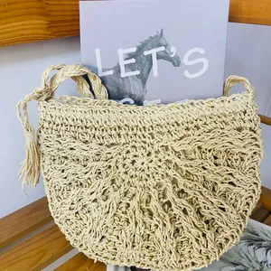 Close-up of hand-woven paper rope shoulder bag with tassel, perfect for summer beach