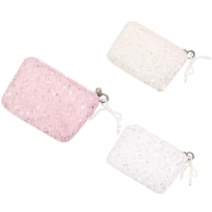 Elegant sequin mini coin purses in pink and white with decorative pearl zipper tassels