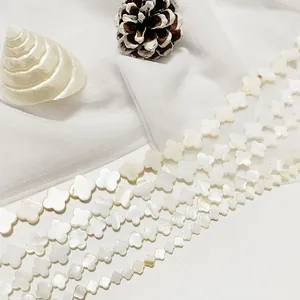 Detailed view of natural white shell four-leaf clover beads for DIY jewelry making