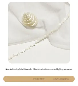 Detail shot of natural white shell beads in a clover flower shape for DIY jewelry