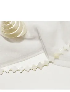 Macro detail of natural white shell four-leaf clover beads for DIY jewelry craft