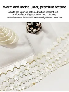 Macro view of natural white shell clover-shaped beads with elegant pearlescent luster