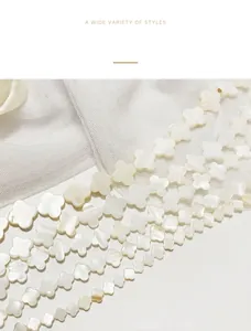 Detailed macro view of natural white mother of pearl clover beads for DIY jewelry.
