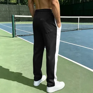 Premium men's athletic joggers with contrast side stripe on professional tennis court
