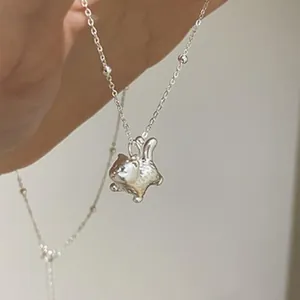 Close-up of a 925 sterling silver necklace featuring a cute cat-shaped pendant
