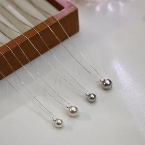 Close-up detail of 925 sterling silver necklaces with 8mm and 10mm pearl pendants