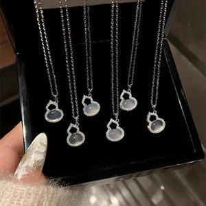 Close-up of elegant 925 sterling silver gourd pendant necklaces with moonstone
