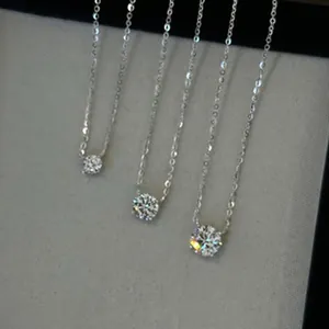 Close-up of three elegant silver necklaces featuring round-cut brilliant stones in various sizes