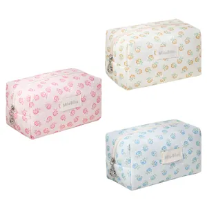 Three lace jacquard floral cosmetic bags in pink blue and cream yellow storage pouches