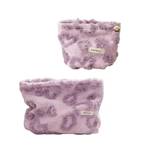 Cute lavender plush heart pattern makeup bag with soft fuzzy texture and flower zipper