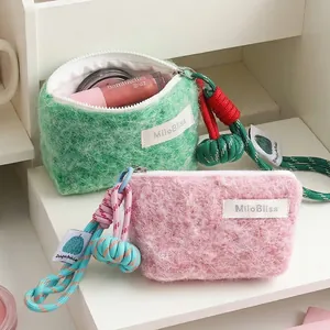 Soft fuzzy mini coin purse with colorful braided rope lanyard for lipstick and earphones.