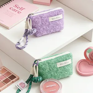Mini fuzzy cosmetic bag with woven lanyard for lipsticks and coins, pastel purple and green