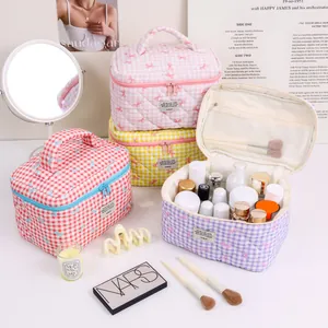 Cute quilted gingham makeup bag with bow detail and portable top handle for travel storage