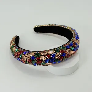Close-up of luxury Baroque headband with colorful rhinestones on black padded base
