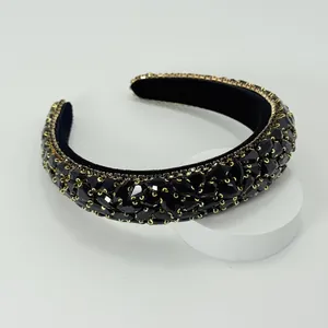 Close-up of Baroque padded headband featuring black faceted rhinestones and gold claws