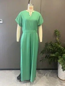 Detail view of a green V-neck short sleeve wide-leg jumpsuit on a mannequin