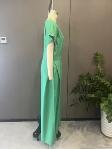 Detailed side view of an elegant green wide-leg jumpsuit displayed on a mannequin