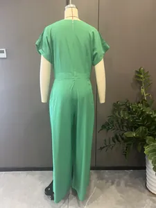 Rear view of an elegant green V-neck wide-leg jumpsuit displayed on a mannequin.
