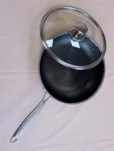 Detailed close-up view of a 316L stainless steel honeycomb frying pan with glass lid